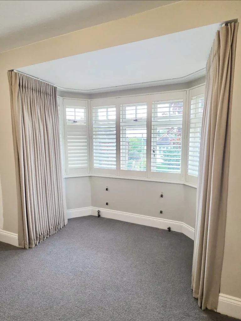 9. The Bay Window Solution: Custom Pinch-Pleat Curved Rod